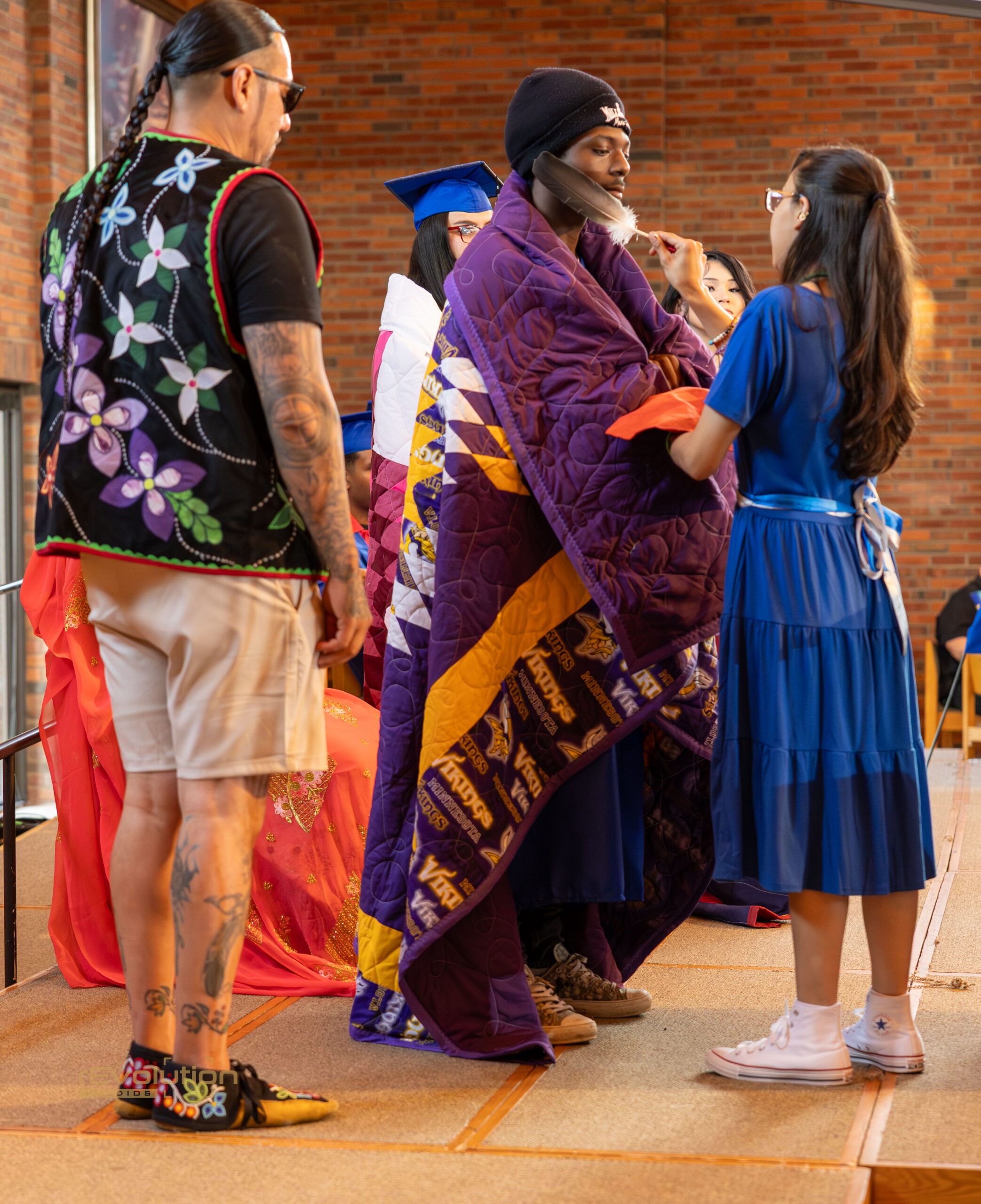 AFA graduate receiving a handmade quilt during graduation
