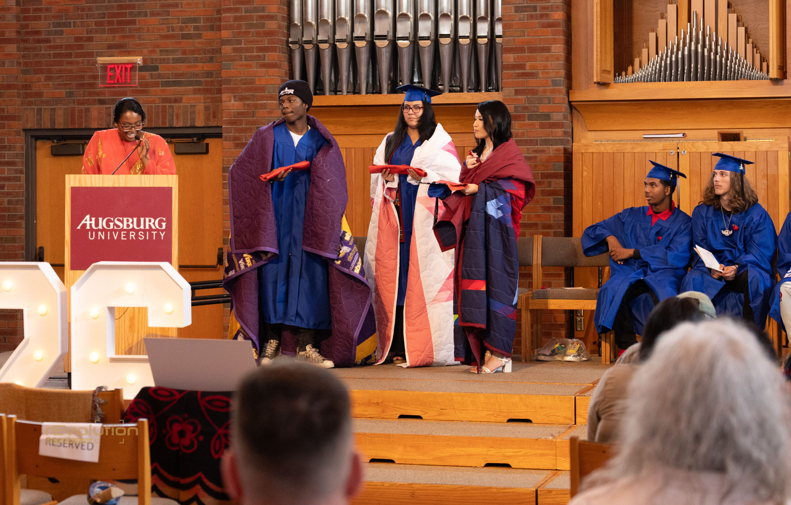 AFA graduation ceremony honoring students with handmade quilts
