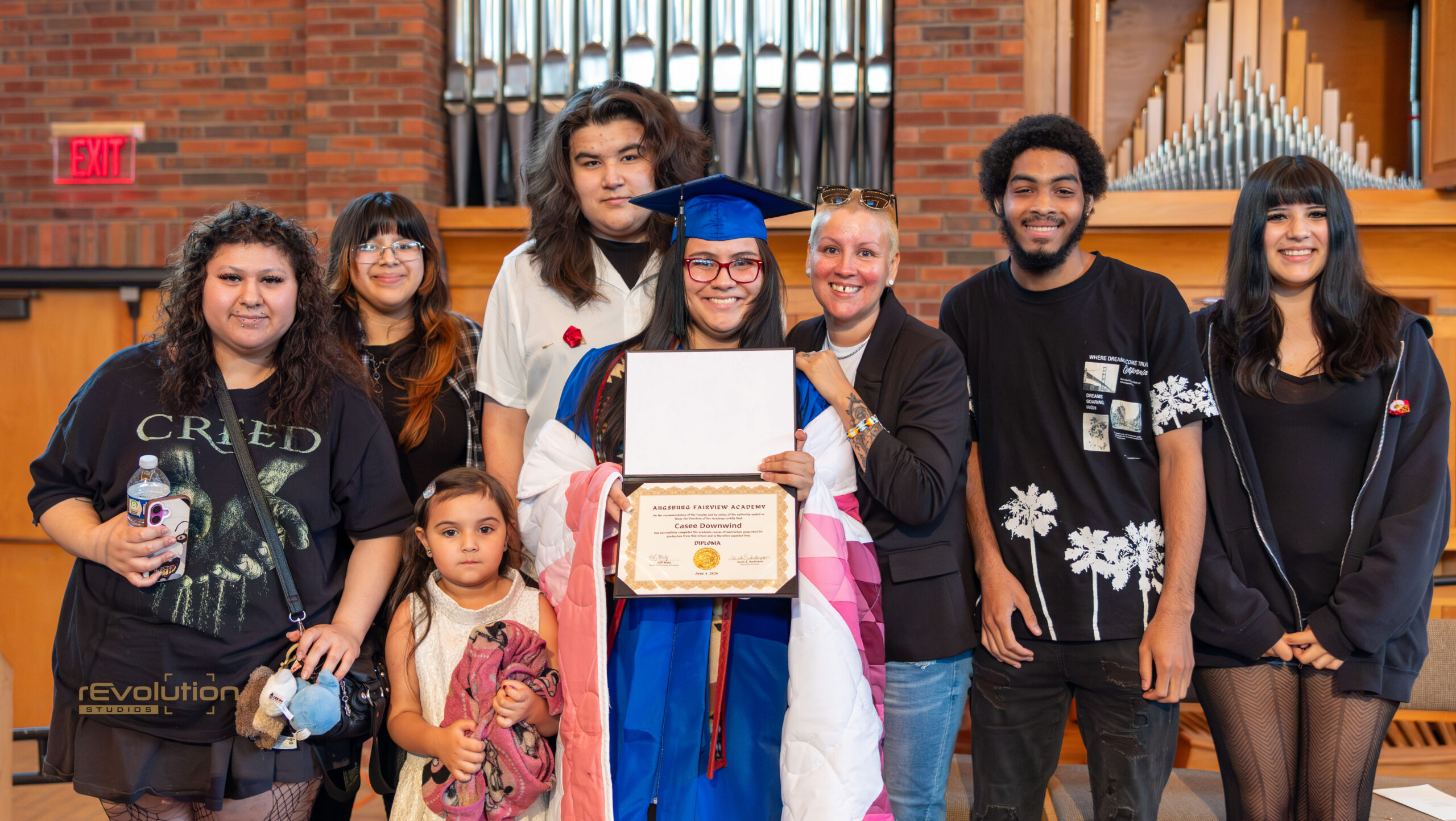 AFA graduate surrounded by family, friends, staff, and supporters